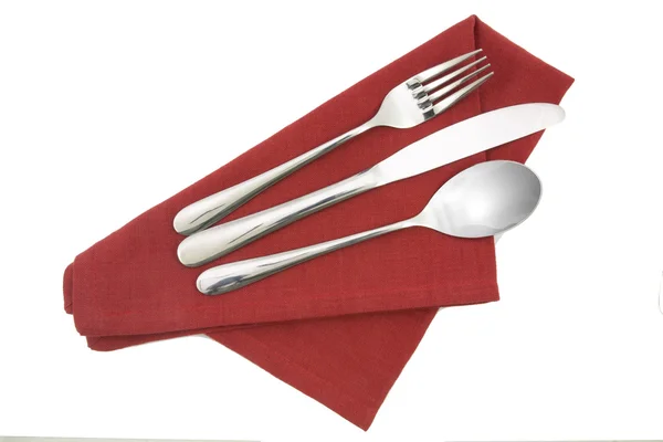 Fork and knife on red napkin isolated — Stock Photo, Image