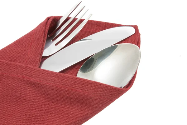 Вилка и нож на красной салфетке изолированы — стоковое фото