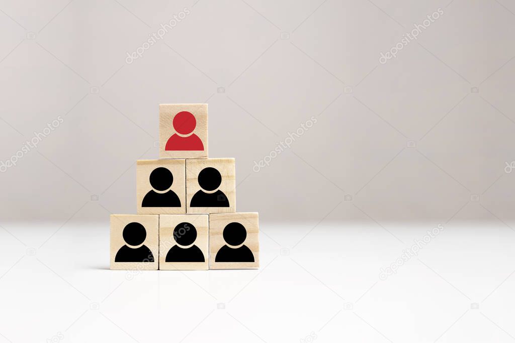 Business hierarchy chart made of wooden cubes on table, copy space. Company, organization structure. Leader and employees team. Building of effective business model.