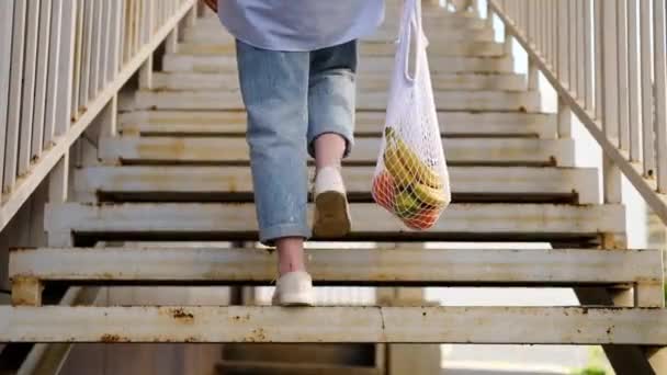 Mujer Jeans Subiendo Sosteniendo Bolsa Malla Blanca Con Frutas Eco — Vídeos de Stock