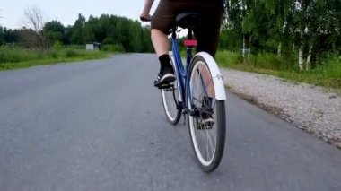 Kırsal kesimde ormanda bisiklet süren erkek bacakları. Yaz aktivitesi, sağlıklı yaşam tarzı, egzersiz, spor, fitness. Doğada yalnız bir insan. Dışarıda eğleniyoruz..