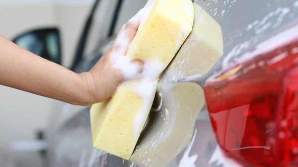 Woman Washing a car with a sponge and soap. — Stock Photo, Image