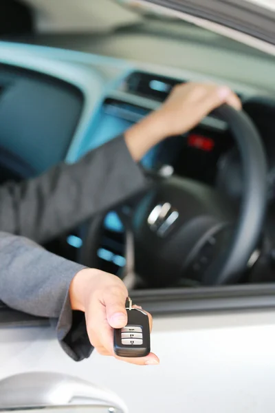 Business woman show a remote key. — Stock Photo, Image