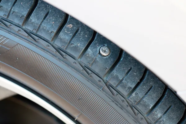 Screw nail puncturing tire. — Stock Photo, Image