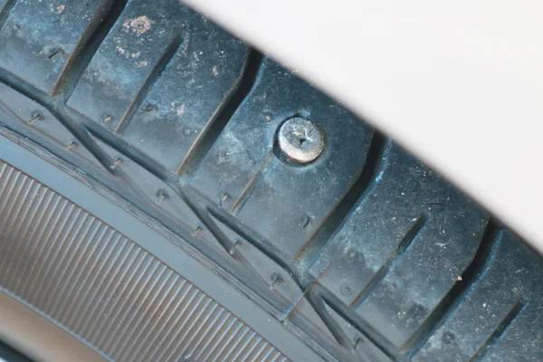 Screw nail puncturing tire. — Stock Photo, Image