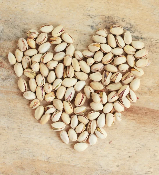 Pistachio nuts in heart shape — Stock Photo, Image