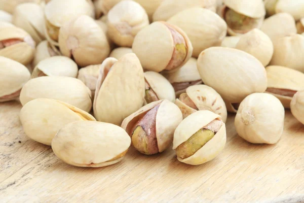 Pistachio nut on wood background. — Stock Photo, Image