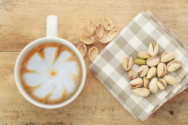 Pistachio nut and white coffee cup. — Stock Photo, Image