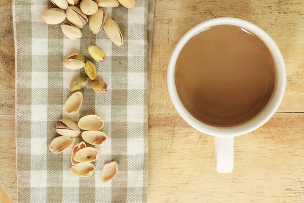 Coffee with nut on wood background — Stock Photo, Image