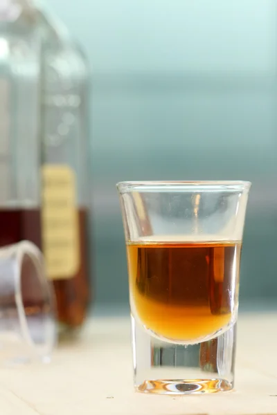 Close up glass of brandy on wood table. — Stock Photo, Image