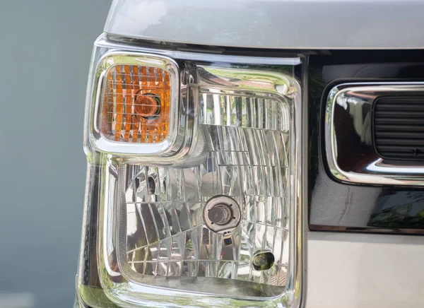 Vehicles front head lamp close up photo.