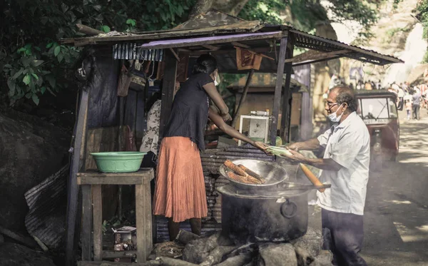 スリランカ 2021年 顔のマスクを持つ男によって地元の女性ベンダーからRawanaエラの近くのストリートフードを購入し おいしいゆで卵と焼きとうもろこしを販売 — ストック写真