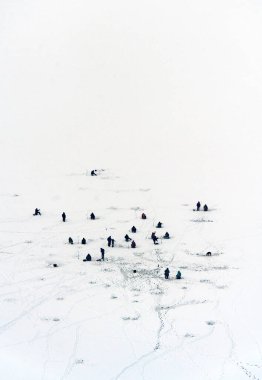 Rusya 'nın Nizhny Novgorod yakınlarındaki donmuş Volga nehrinde bir grup buzdan balıkçı. Nehrin karşısına geçen bir Cablecar 'dan havadan fotoğraf çekildi..