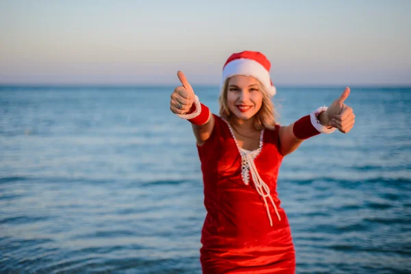 Beautiful girl Santa Claus on the beach — Stock Photo, Image