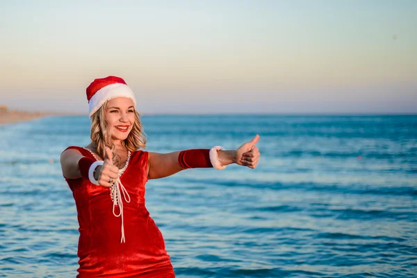 Beautiful girl Santa Claus on the beach — Stock Photo, Image