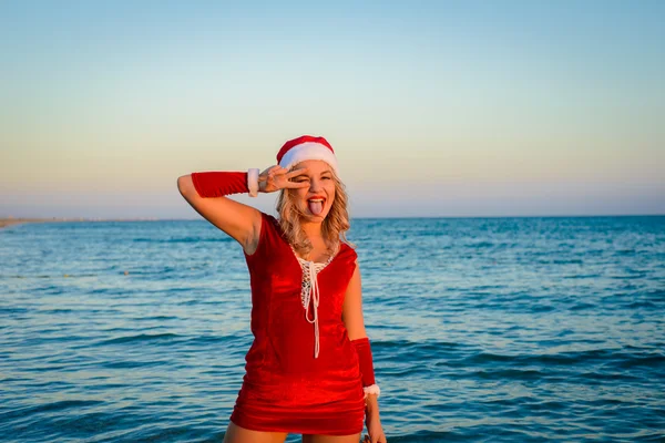 Beautiful girl Santa Claus on the beach — Stock Photo, Image