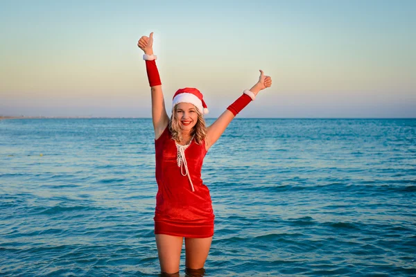 Beautiful girl Santa Claus on the beach — Stock Photo, Image