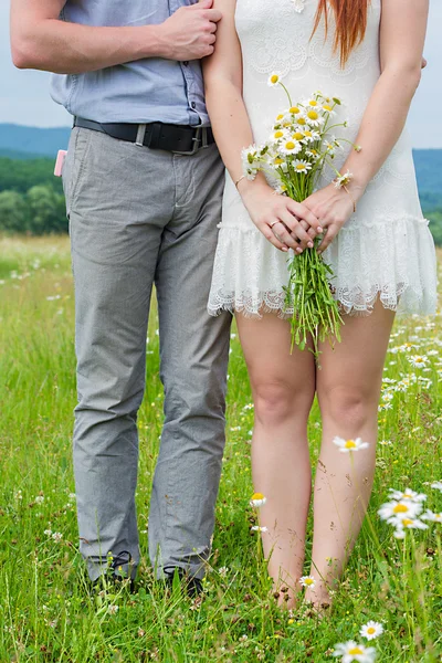 Beautiful couple in love on camomile field — Stock Photo, Image