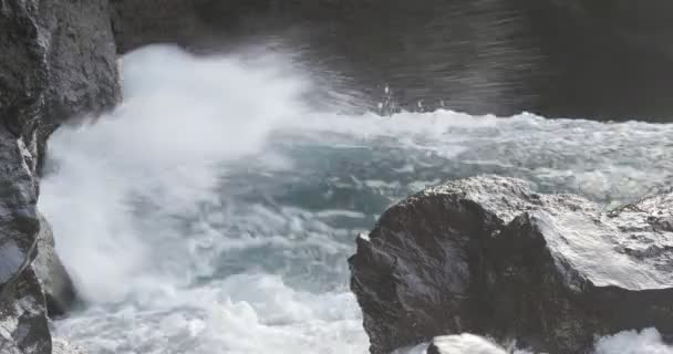 4K, Dramáticas olas de agua salpicando y estrellándose contra las rocas — Vídeo de stock