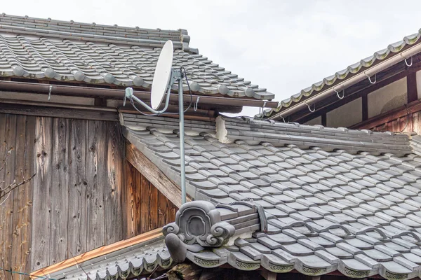 Satellite dish on old traditional houses. Kumagawa, a small village on the historic trading route from Kyoto to Fukui, Japan.