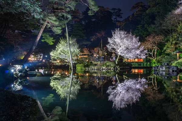 Kenrokuen gardens by night, reflected in water, Kanazawa, Japan