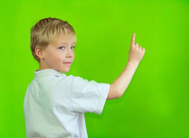 Krom anahtarın arka planında beyaz tişörtlü bir çocuk parmağını gösteriyor. Metin için boşluk, kopyala boşluk