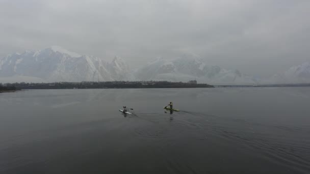 Aerial View Two Kayaks Sailing Cold Sea Backdrop Snow Capped — Stock Video