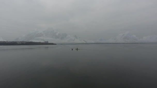 Вид Повітря Два Каяки Пливуть Холодному Морі Тлі Засніжених Гір — стокове відео