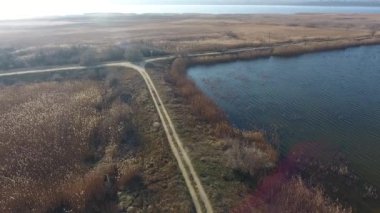 Suni rezervler arasındaki kirli yol batan güneşin arka planına karşı.