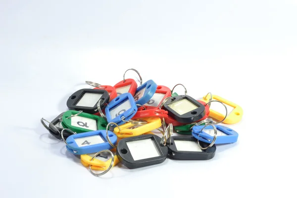 Many color key rings on the white background. — Stock Photo, Image