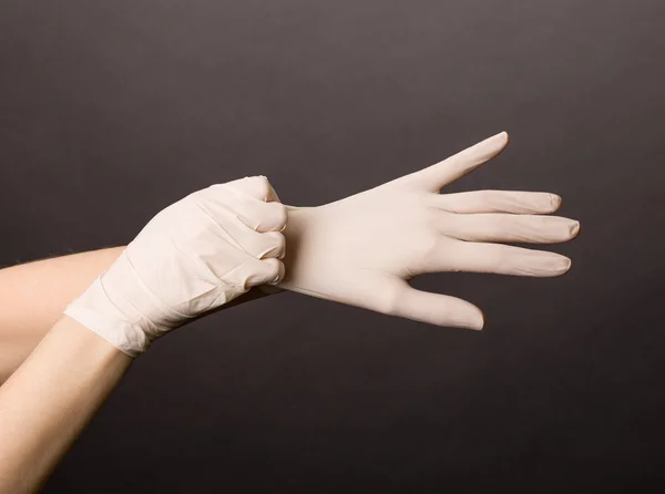 Putting on latex gloves — Stock Photo, Image