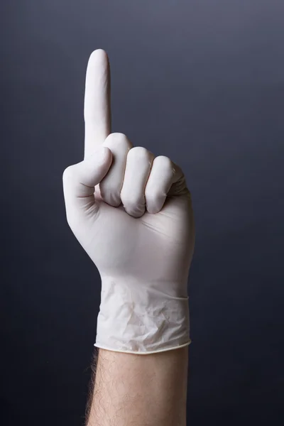 Male hand in latex glove pointing up — Stock Photo, Image