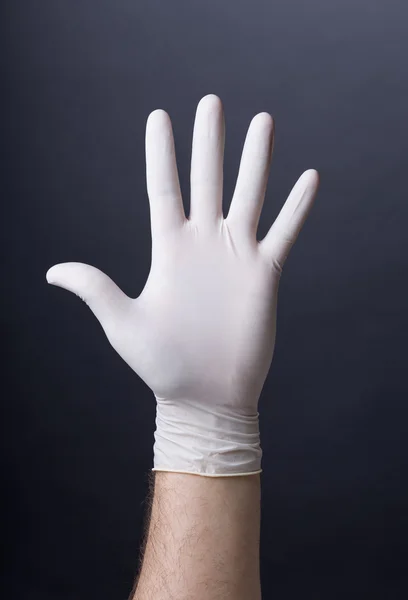 Manlig hand i latex handske — Stockfoto