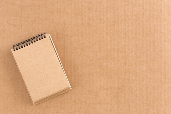 Notepad on cardboard background — Stock Photo, Image