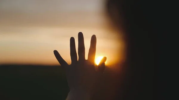 Little child runs across the green football field playing football at sunset in the sky, kid kicks the ball and catches up with him, the concept of a happy childhood life, active healthy baby — Stock Photo, Image