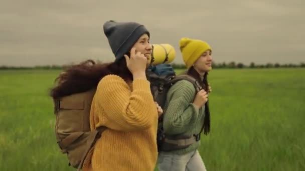 Le ragazze felici viaggiatori vanno con zaini e sorriso, felicità di viaggio, sogno delle donne, giorno libero nella natura, escursioni a lunga distanza, sport stile di vita sano, gli amanti delle escursioni e le avventure del — Video Stock