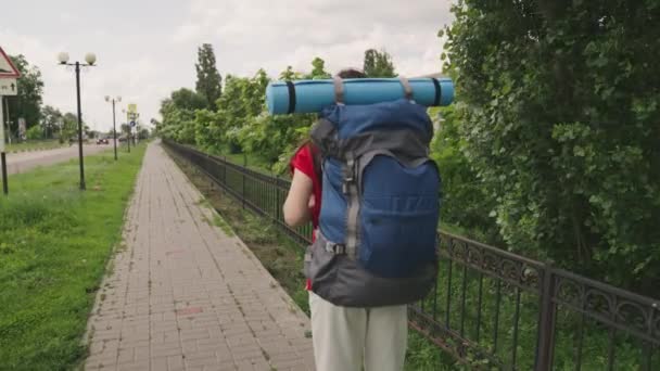 青いバックパックとヨガマットの旅を持つ少女旅行千年紀、冒険、幸せな生活、ハイキング休暇を求めて地元のアトラクションを探索し、自然を屋外で楽しむ、スローモーション — ストック動画