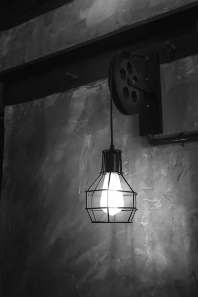 一盏灯挂在伦敦一家酒吧里的金属框架灯灯系在一个旧滑轮上 — 图库照片