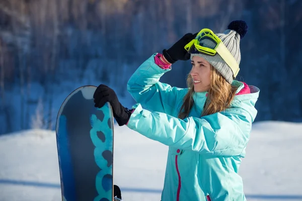 Portrait of beautiful cheerful woman with a snowboard — Stock Photo, Image