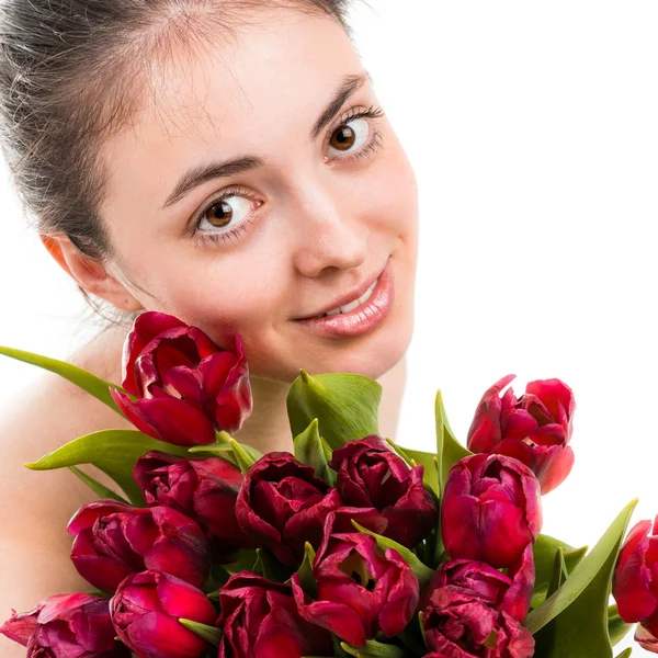 Portret van mooie jonge vrouw met tulpen — Stockfoto