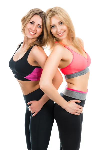 Portrait of two cheerful young sports women  on a white background Stock Image