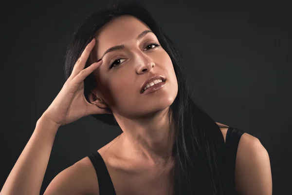 Portrait of a beautiful young woman on a black background — Stock Photo, Image