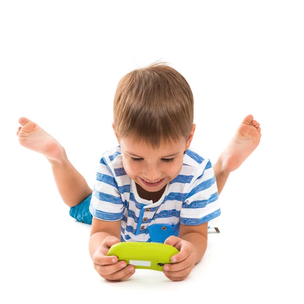 Criança feliz jogando um console de jogo. Foto sobre um fundo branco — Fotografia de Stock