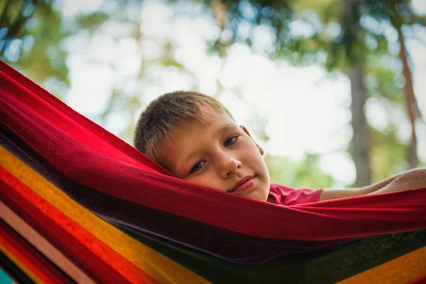 Portrait of a cheerful teenager in a hammock — Stock Photo, Image