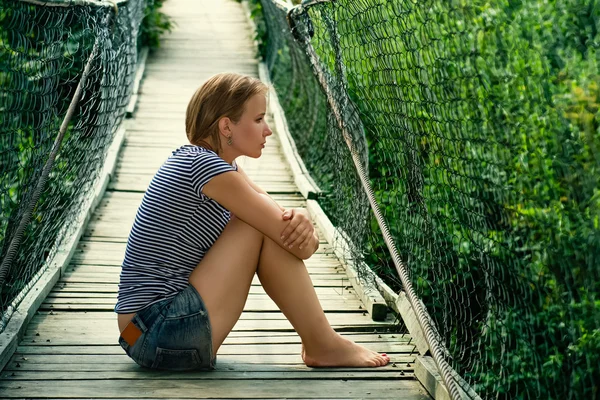 Portrait of a sad girl on the bridge — Stock Photo, Image