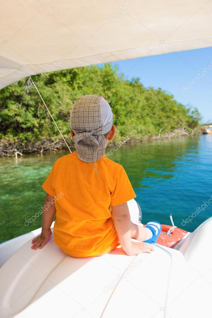 Child floats on a catamaran on the picturesque Lake