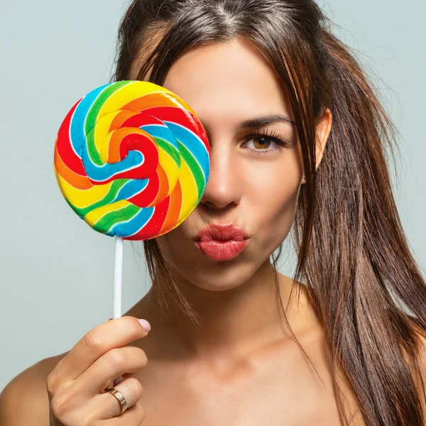 Portrait of a beautiful sexy woman with candy — Stock Photo, Image