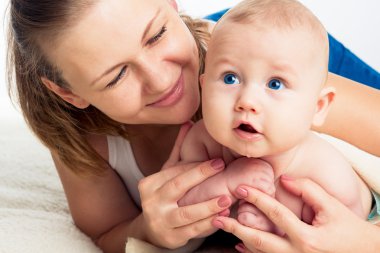 Aile. Çocuklu bir kadın. Bir bebek ile güzel gülümseyen genç anne Portresi