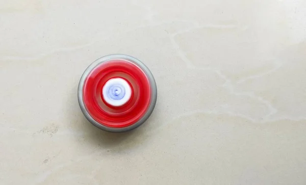 Top view of a beyblade spinning Motion blur effect on white tiles background