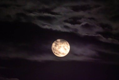 Gökyüzünde dolunay bulutlarla kaplı.